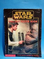 Front cover of the 1997 Star Wars Pull-Out Poster Book showing Han Solo touching a Gamorrean Guard, with visible wear and creasing on the black bordered cover.