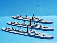 Top-down view showing all three gray diecast miniature ships with detailed deck, masts, and ship features.