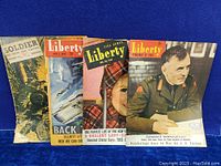 Front view of all four vintage magazines showing cover art and condition.