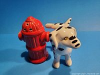 Side view of red fire hydrant and Dalmatian dog salt and pepper shakers.