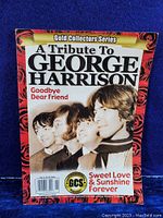Magazine cover showing the title 'A Tribute To George Harrison' with a vintage black and white photo of The Beatles.