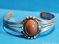 Full view of the vintage silver bracelet with central sunstone and decorative silver detailing, showing overall design and condition.