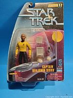 Front view of unopened Star Trek Warp Factor Series 1 Captain Benjamin Sisko action figure in original packaging showing figure, accessories, and box details.