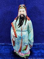 Full view of signed Fu Chinese deity statue standing 8 1/4 inches tall with hand-painted details and textured stoneware surface.
