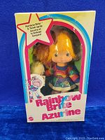 Front view of the Rainbow Brite Azurine doll in original box featuring colorful graphics and doll visible through window.