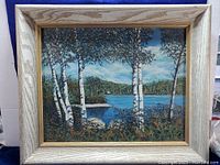 Frontal view of the framed painting showing the entire artwork and frame in natural light.