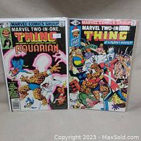 Photo showing Marvel Two-In-One comic issues 57 and 74 standing side by side, both bagged and boarded.