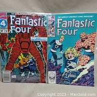 Two Fantastic Four comic books with distinctive cover art showing characters including Doctor Doom and The Devastator, bagged and boarded.
