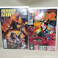 Front cover of Heroes for Hire #2 and The Mighty Thor #430 comic books, showing main characters and clear protective bags