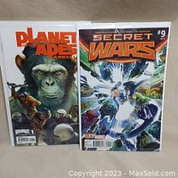 Both comic books positioned side by side showing their front covers: Secret Wars #9 and Planet of the Apes Annual #1, each in a protective bag and board.