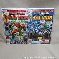 Two Marvel Premiere comic books #35 and #37, each featuring 3-D Man, displayed side by side in protective sleeves.