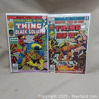Photo showing both Marvel Two-in-One comic books, issue 24 and 25, with cover artwork featuring The Thing with Black Goliath and Iron Fist.