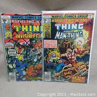 Both comic books side by side, showing full covers of Marvel Two-in-One issue 32 and 43 in protective sleeve.