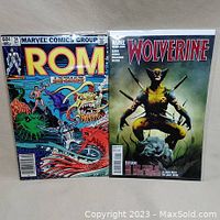 Photo showing front covers of ROM #34 and Wolverine #1 comics, bagged and boarded.
