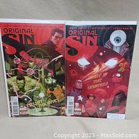 Photo showing two Original Sin comic books, issues 4 and 5, bagged and boarded with cover art visible.