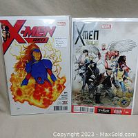 Front covers of X-Men Red #1 and X-Men Gold #1 comics shown side by side in protective bags.