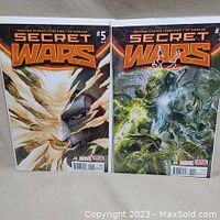 Two Marvel Secret Wars comic books, issues #5 and #6, bagged and boarded, side-by-side showing the front covers with striking artwork representing Dr. Doom and other characters.