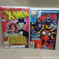 Photo of X-Men #179 and The Sensational Spider-Man #18 comics side by side, both bagged and boarded.