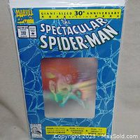 Front of comic book in bag and boarded, showing holographic cover with Spider-Man image and 30th anniversary text.