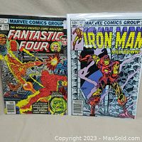 Photo showing front covers of Fantastic Four #189 and Iron Man #165 comic books side by side displaying the artwork and titles