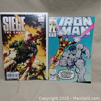 Photo showing cover of Siege The Cabal and Iron Man #247 comics bagged and boarded.