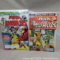 Two bagged and boarded comic books, Amazing Adventures War of the Worlds issues #21 and #22, displayed upright side by side showing full front covers.
