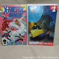 Photo showing both comic books side by side, X-Factor Annual #1 and Winter Soldier #1, both bagged and boarded.