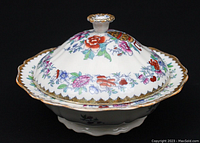 Side view of antique Royal Doulton vegetable tureen with lid showing the Japan pattern floral and oriental motif with scalloped and gilt edges.