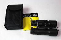 Photo showing binoculars, case, and user manual from front angle.