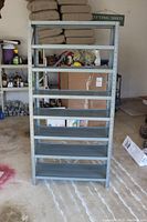 Front view of powder-coated steel metal shelf organizer with seven flat shelves, showing overall height and width.