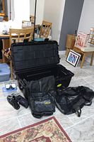 Overview photo of full diving gear lot showing large Plano storage tote, Cressi Orca mesh bag, small mesh bag, diving booties, and accessory pouch.