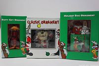 Front view showing all three ornaments in original boxes: Daffy Duck, Taz, Bugs Bunny Holiday Bag.