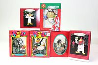 Photo showing six Looney Tunes character Christmas ornaments with their original boxes arranged standing and stacked. Characters include Daffy Duck, Foghorn Leghorn holding a mug, Taz, Marvin the Martian, Pepe Le Pew, and Wile E. Coyote in festive packaging.