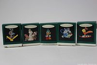 Five original boxed Tiny Toon Adventures character Christmas ornaments shown from front side with character image on small box.
