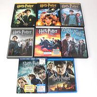 Front view showing all 8 Harry Potter movie cases arranged in three rows, featuring various editions mainly in DVD and Blu-ray format.