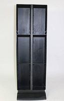 Front view of Laserline black plastic DVD/CD storage rack showing four vertical sections and base