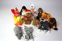 Front view of 12 vintage Beanie Babies with tags, showing variety of animals and characters in the lot.