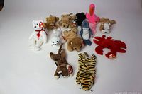 Lot of 12 vintage Ty Beanie Babies arranged on a white background, showing front and top views.