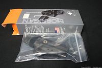 Raven Morrigan holster in clear plastic bag with original open box showing black and orange design.