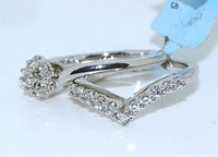 Photo of two sterling silver bridal rings side by side displaying round cut clear stones and a size tag attached