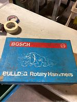 Closed blue metal Bosch Bulldog case with branding on the top.