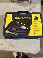 Closed plastic carrying case labeled 'Home Entertainment CATV/Satellite Tool Kit' by DataShark with images of included tools on front.