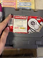 Close-up of Craftsman label on gray plastic case stating 10-piece, 3/8 inch drive metric socket wrench set