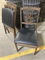 Three wood and faux leather folding chairs showing seating and decorative carved backrest detail.
