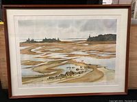Framed signed print showing Digby Nova Scotia coastal scene with tidal flats and water channels under a cloudy sky. Wooden frame with minor scratches, glass covered.