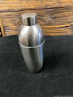Closed view of stainless steel Mid Century Lundtofte cocktail shaker showing smooth rounded shape and metallic finish.