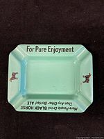 Top view showing text 'For Pure Enjoyment' and 'More People Drink Black Horse Than Any Other Bottled Ale' with black horse illustrations