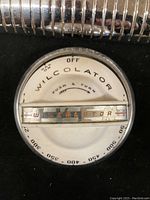 Front view of round Wilcolator stove dial with temperature numbers and clear plastic temperature scale.