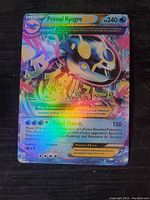 Front side of Primal Kyogre EX holo foil Pokemon card showing the Pokemon image, stats, and holographic effects.