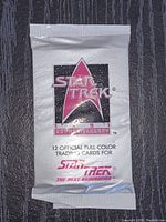 Sealed pack of Star Trek The Next Generation 25th Anniversary trading cards with white foil packaging and 25th Anniversary logo.